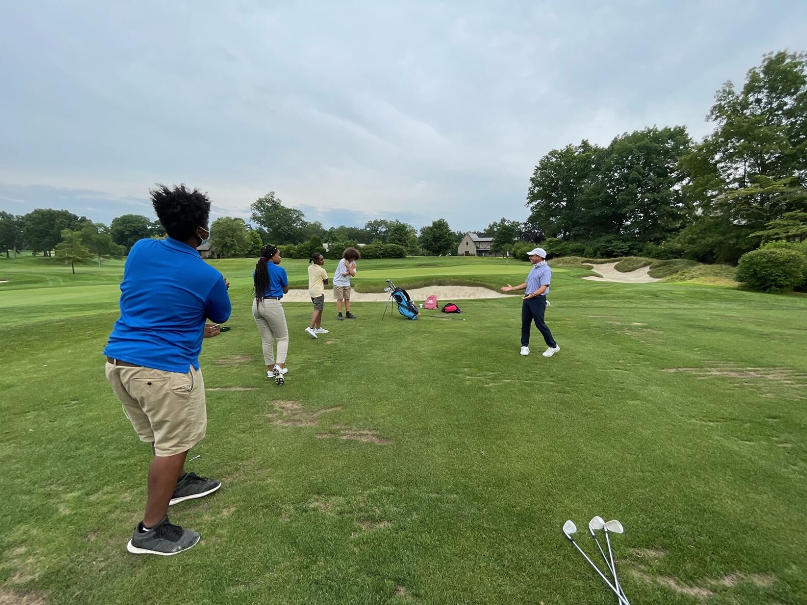 Quaker Ridge fellows during a golf lesson