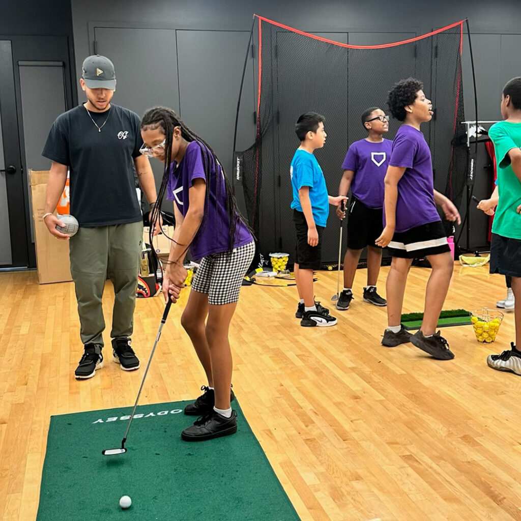 DREAM student with golf instructor Omari Whitmore